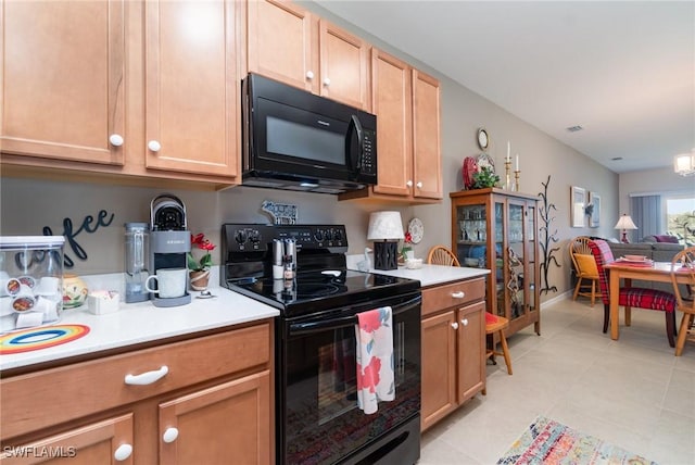 20095 Fiddlewood Ave, North Fort Myers, FL 33917 - kitchen with black appliances, light countertops, light tile patterned flooring, and open floor plan