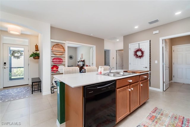 20095 Fiddlewood Ave, North Fort Myers, FL 33917 - kitchen with black dishwasher, light countertops, an island with sink, recessed lighting, and light tile patterned floors
