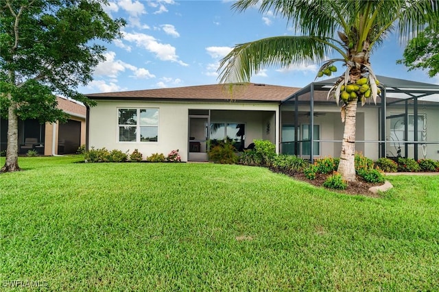 20095 Fiddlewood Ave, North Fort Myers, FL 33917 - rear view of house with stucco siding, a lawn, and glass enclosure