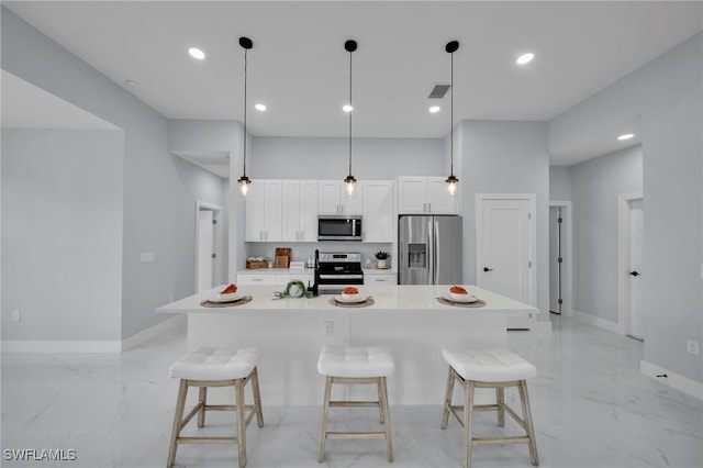 3706 16th St W, Lehigh Acres, FL 33971 - kitchen featuring stainless steel appliances, light marble finish flooring, a kitchen bar, and recessed lighting