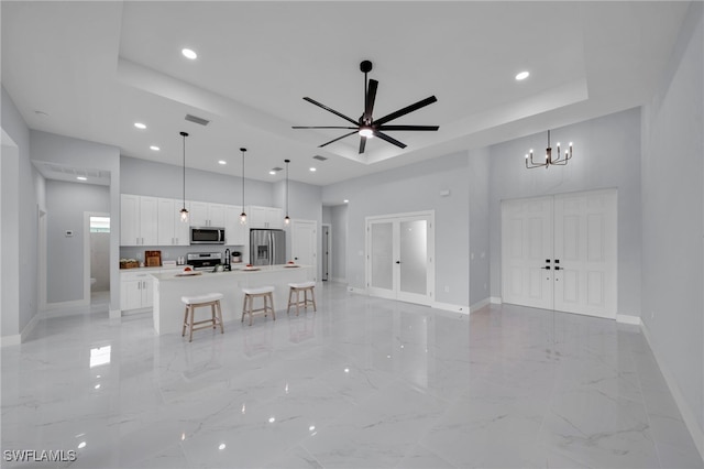 3706 16th St W, Lehigh Acres, FL 33971 - living area featuring a tray ceiling, a towering ceiling, recessed lighting, light marble finish floors, and a ceiling fan