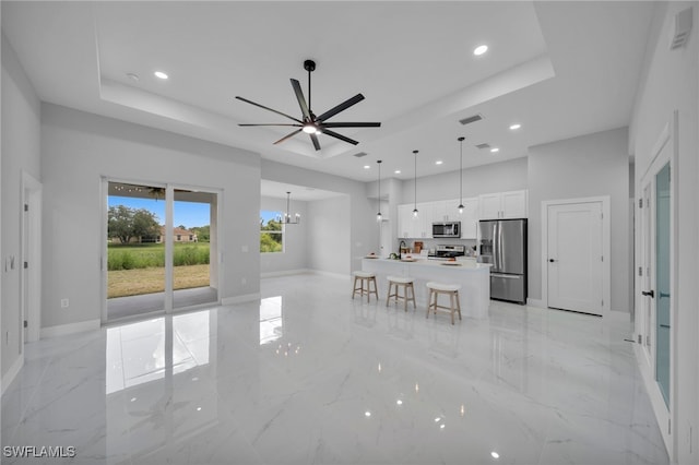 3706 16th St W, Lehigh Acres, FL 33971 - living area with a raised ceiling, light marble finish flooring, recessed lighting, a ceiling fan, and a chandelier