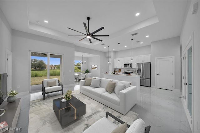 3706 16th St W, Lehigh Acres, FL 33971 - living area featuring a raised ceiling, recessed lighting, light marble finish flooring, ceiling fan, and a towering ceiling