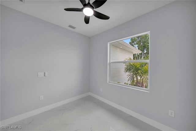 3706 16th St W, Lehigh Acres, FL 33971 - empty room with a ceiling fan and marble look tiles