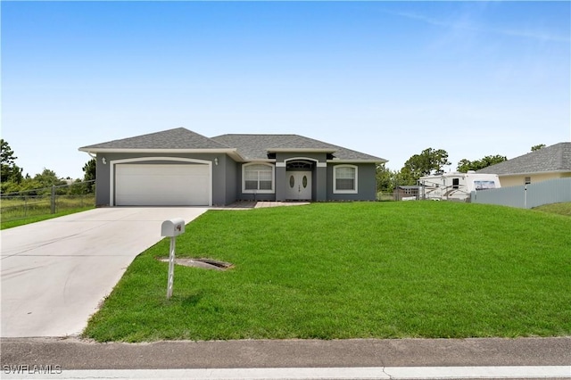 902 E 10th St, Lehigh Acres, FL 33972 - view of front of home featuring an attached garage, driveway, stucco siding, and roof with shingles