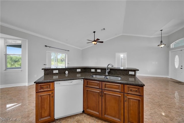 902 E 10th St, Lehigh Acres, FL 33972 - kitchen with white dishwasher, plenty of natural light, lofted ceiling, ceiling fan, and brown cabinets