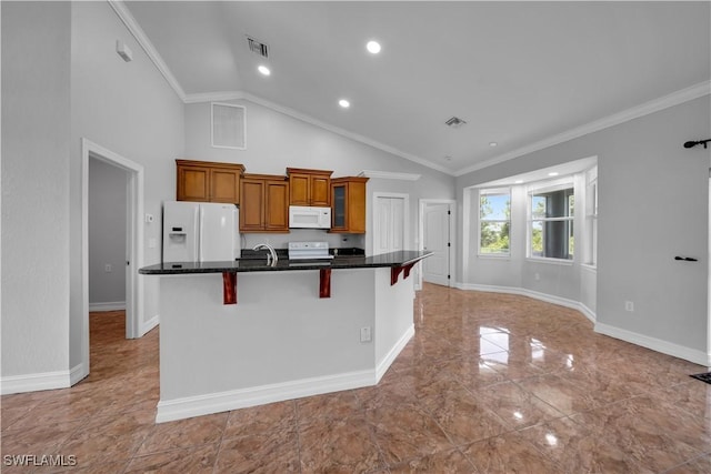 902 E 10th St, Lehigh Acres, FL 33972 - kitchen with white appliances, a large island with sink, brown cabinetry, a kitchen bar, and crown molding