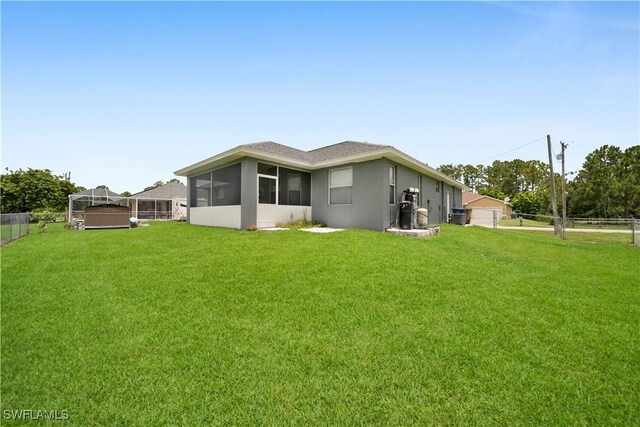902 E 10th St, Lehigh Acres, FL 33972 - back of property featuring a sunroom and stucco siding