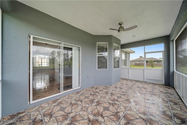 902 E 10th St, Lehigh Acres, FL 33972 - unfurnished sunroom featuring a ceiling fan