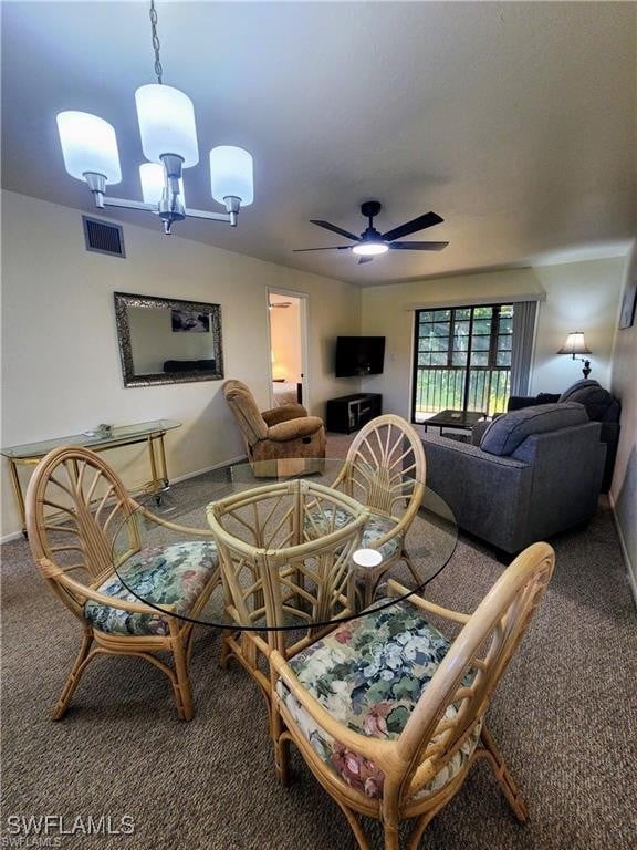 1221 Barrett Rd Unit 905, North Fort Myers, FL 33903 - dining room featuring carpet flooring, a ceiling fan, and a chandelier