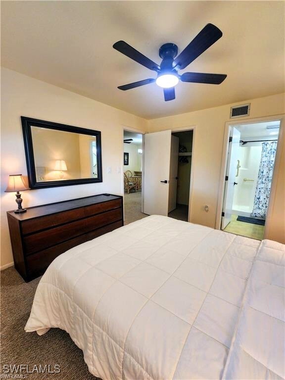 1221 Barrett Rd Unit 905, North Fort Myers, FL 33903 - bedroom with carpet flooring, connected bathroom, a walk in closet, and ceiling fan