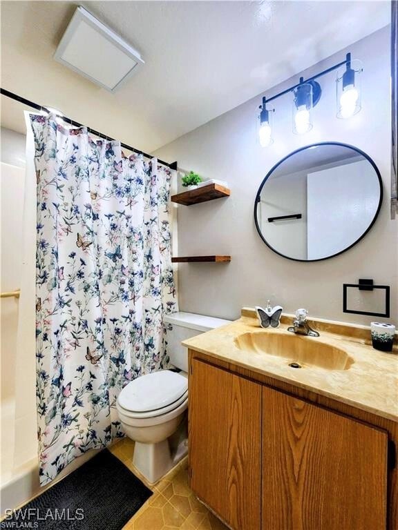 1221 Barrett Rd Unit 905, North Fort Myers, FL 33903 - full bathroom featuring vanity, tile patterned flooring, and shower / bath combo