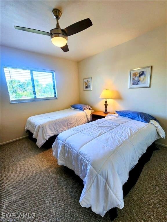 1221 Barrett Rd Unit 905, North Fort Myers, FL 33903 - carpeted bedroom featuring a ceiling fan and baseboards