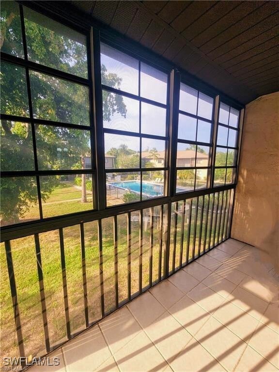 1221 Barrett Rd Unit 905, North Fort Myers, FL 33903 - unfurnished sunroom featuring plenty of natural light
