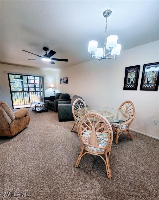 1221 Barrett Rd Unit 905, North Fort Myers, FL 33903 - carpeted dining area featuring a chandelier and a ceiling fan