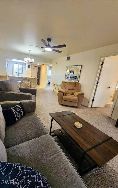 1221 Barrett Rd Unit 905, North Fort Myers, FL 33903 - carpeted living area featuring ceiling fan and a chandelier