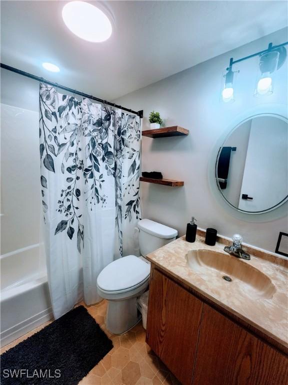 1221 Barrett Rd Unit 905, North Fort Myers, FL 33903 - full bath with vanity, shower / bathtub combination with curtain, and tile patterned flooring