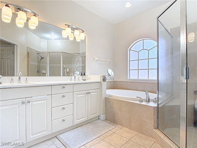 14031 W Hyde Park Dr Unit 201, Fort Myers, FL 33912 - bathroom featuring double vanity, a shower stall, tile patterned flooring, and a garden tub