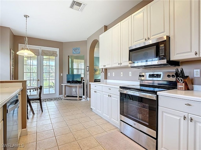 14031 W Hyde Park Dr Unit 201, Fort Myers, FL 33912 - kitchen with stainless steel appliances, arched walkways, light countertops, light tile patterned floors, and pendant lighting