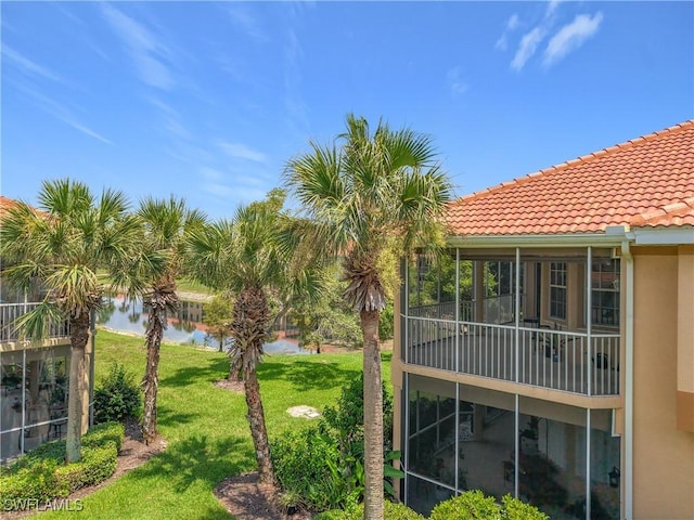 14031 W Hyde Park Dr Unit 201, Fort Myers, FL 33912 - view of grassy yard with a sunroom and a water view