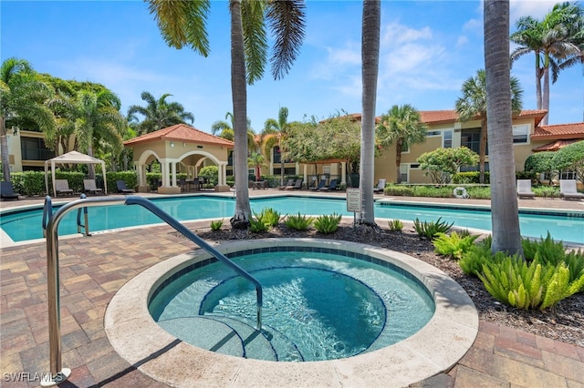 8851 Colonnades Ct W Unit 128, Bonita Springs, FL 34135 - community pool featuring a hot tub, a patio, and a gazebo