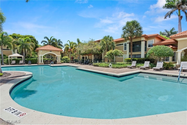 8851 Colonnades Ct W Unit 128, Bonita Springs, FL 34135 - community pool with a patio area