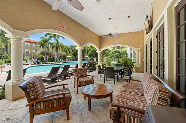 8851 Colonnades Ct W Unit 128, Bonita Springs, FL 34135 - view of patio with a ceiling fan, a community pool, and french doors