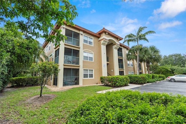 8851 Colonnades Ct W Unit 128, Bonita Springs, FL 34135 - view of property featuring uncovered parking