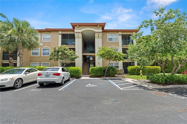 8851 Colonnades Ct W Unit 128, Bonita Springs, FL 34135 - view of building exterior with uncovered parking