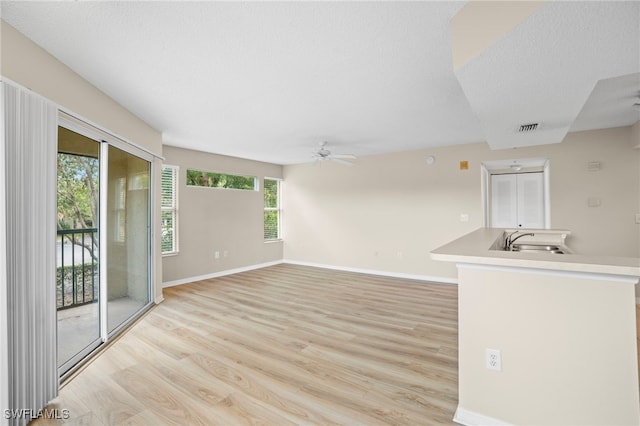 8851 Colonnades Ct W Unit 128, Bonita Springs, FL 34135 - unfurnished living room with light wood-style flooring and ceiling fan