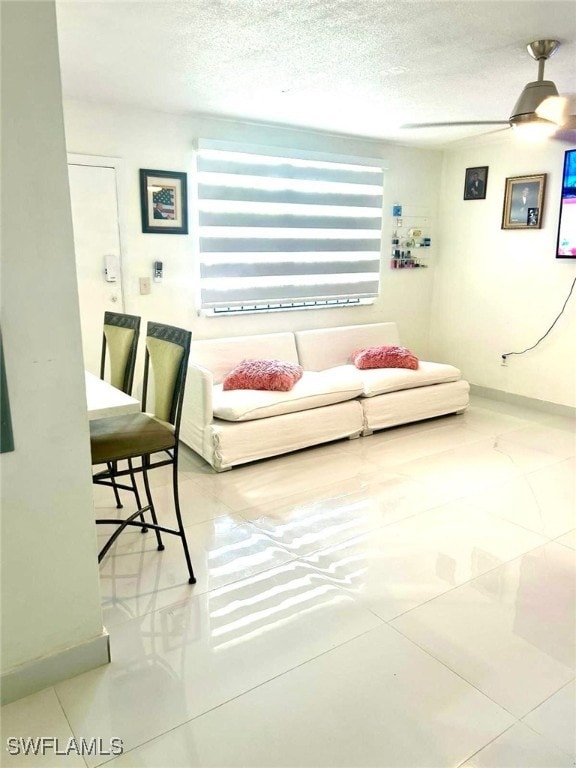 1395 NE 167th St # 107, North Miami Beach, FL 33162 - living area with tile patterned flooring, a ceiling fan, and a textured ceiling