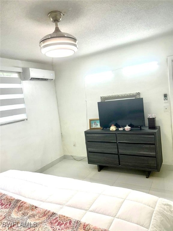 1395 NE 167th St # 107, North Miami Beach, FL 33162 - tiled bedroom with a wall unit AC and a textured ceiling