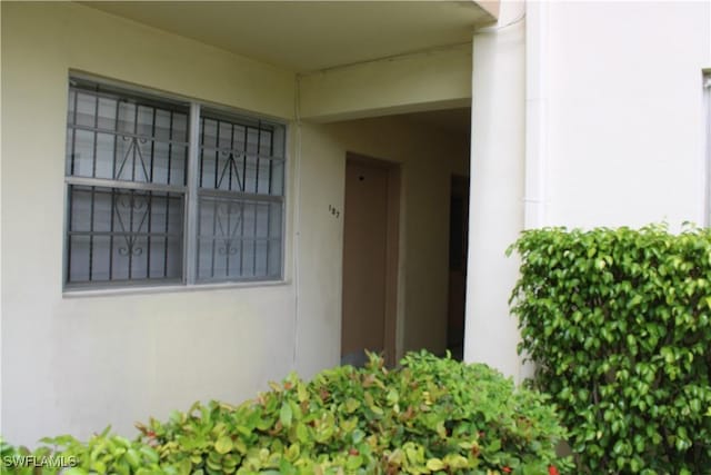 1395 NE 167th St # 107, North Miami Beach, FL 33162 - view of exterior entry featuring stucco siding