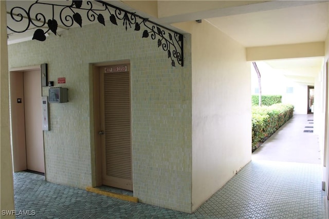 1395 NE 167th St # 107, North Miami Beach, FL 33162 - property entrance featuring elevator and stucco siding