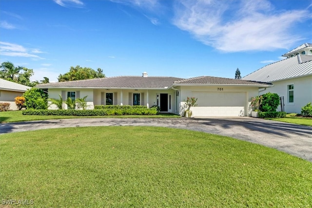 701 Harbour Dr, Naples, FL 34103 - single story home featuring asphalt driveway, a tiled roof, a chimney, stucco siding, and a front lawn