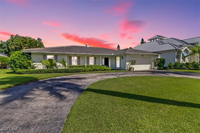 701 Harbour Dr, Naples, FL 34103 - ranch-style house with curved driveway, stucco siding, a garage, a lawn, and a tiled roof