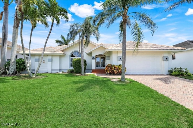 941 Ironwood Ct, Marco Island, FL 34145 - view of front of home with french doors, decorative driveway, a garage, a front yard, and a tiled roof
