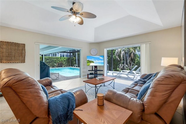 941 Ironwood Ct, Marco Island, FL 34145 - living area with light tile patterned flooring, a ceiling fan, and a tray ceiling