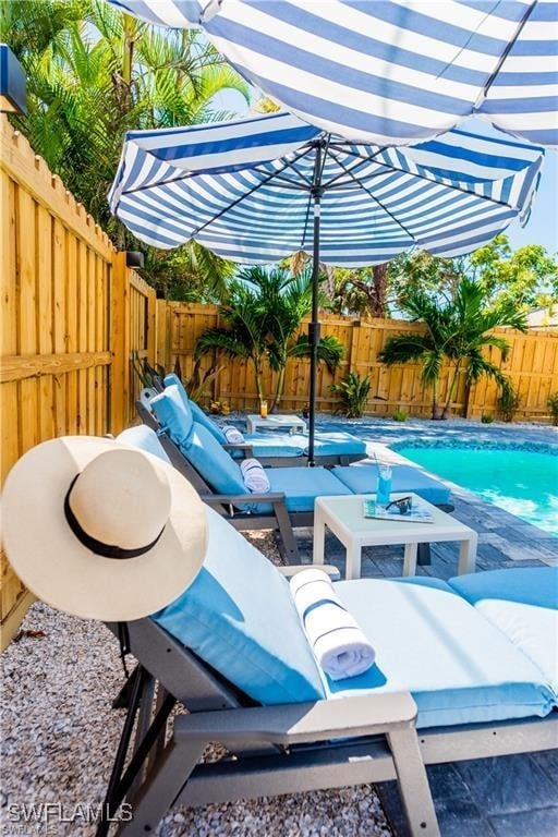 756 108th Ave N, Naples, FL 34108 - fenced backyard featuring outdoor lounge area and a patio