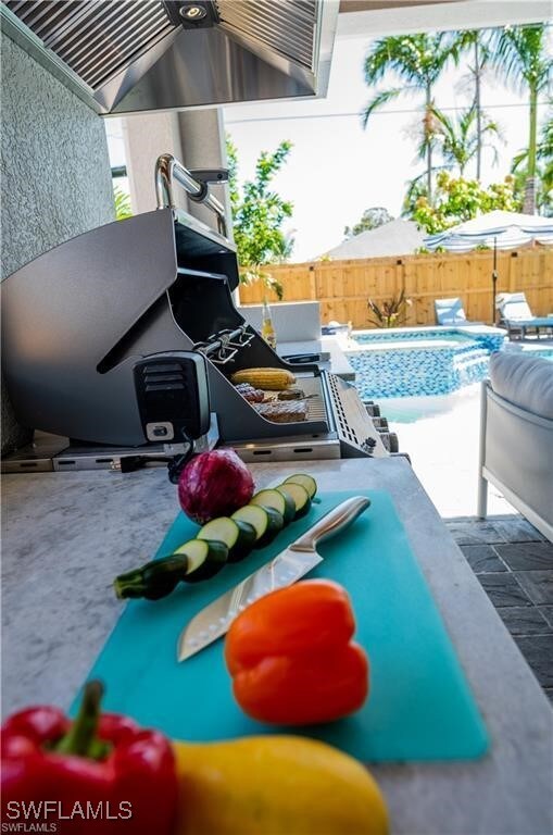 756 108th Ave N, Naples, FL 34108 - view of swimming pool with a jacuzzi and a patio area