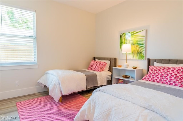 756 108th Ave N, Naples, FL 34108 - bedroom featuring multiple windows and wood finished floors