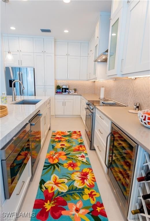 756 108th Ave N, Naples, FL 34108 - kitchen featuring beverage cooler, appliances with stainless steel finishes, white cabinetry, recessed lighting, and glass insert cabinets