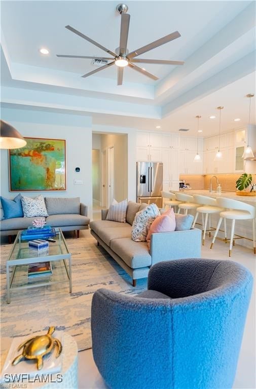 756 108th Ave N, Naples, FL 34108 - living room featuring a raised ceiling, ceiling fan, and recessed lighting