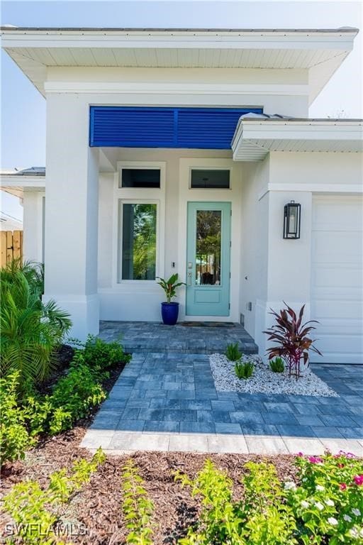 756 108th Ave N, Naples, FL 34108 - entrance to property featuring stucco siding and a garage