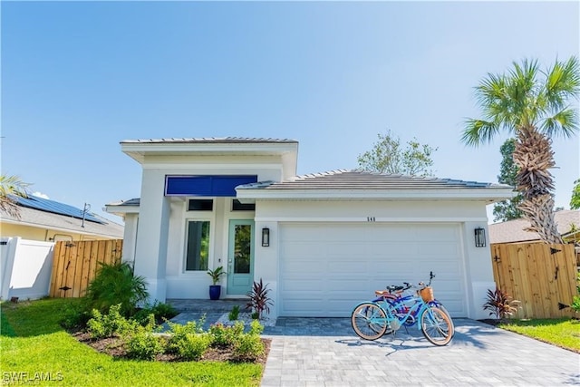 756 108th Ave N, Naples, FL 34108 - view of front of property with a garage, decorative driveway, stucco siding, and a tiled roof