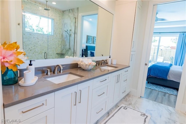 756 108th Ave N, Naples, FL 34108 - ensuite bathroom featuring a marble finish shower, double vanity, healthy amount of natural light, and marble look tiles