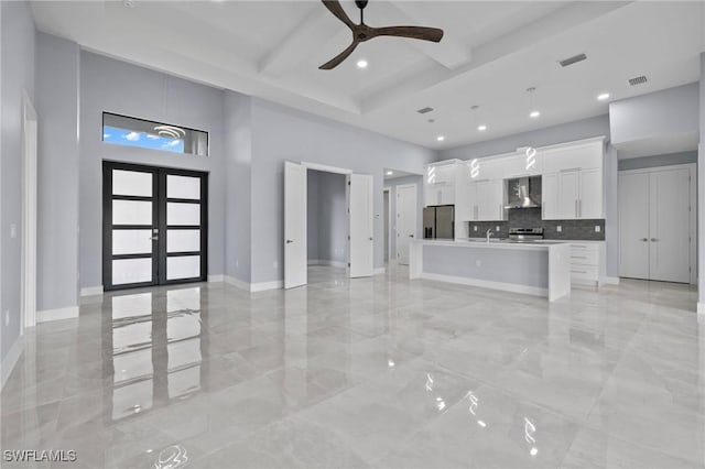 2218 SW 25th St, Cape Coral, FL 33914 - unfurnished living room featuring a ceiling fan, a high ceiling, light marble finish floors, beam ceiling, and recessed lighting