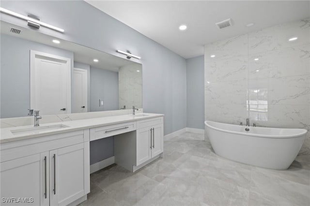 2218 SW 25th St, Cape Coral, FL 33914 - bathroom featuring marble tiled flooring, double vanity, a soaking tub, and recessed lighting