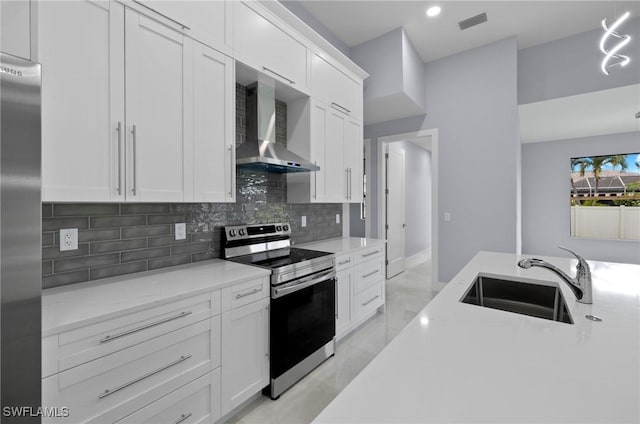 2218 SW 25th St, Cape Coral, FL 33914 - kitchen featuring appliances with stainless steel finishes, wall chimney range hood, decorative backsplash, white cabinetry, and recessed lighting