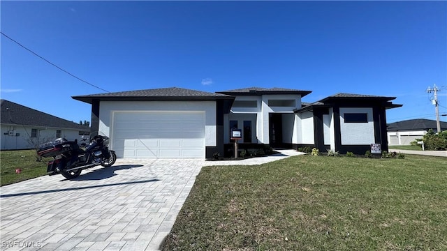 2218 SW 25th St, Cape Coral, FL 33914 - prairie-style house with a garage, decorative driveway, a front lawn, and stucco siding